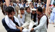 Afghan men carry an injured man to a hospital after a suicide attack, in Jalalabad, Afghanistan October 2, 2018. REUTERS/Parwiz