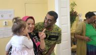 Amnesty International Secretary-General Kumi Naidoo speaks with a refugee woman during his visit to the shelter of the NGO Melissa Network in Athens, Greece, October 5, 2018. Reuters/Karolina Tagaris