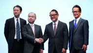 Toyota Motor Corp President Akio Toyoda and Executive Vice President Shigeki Tomoyama poses for a photograph with SoftBank Group Corp Chairman and CEO Masayoshi Son and SoftBank Corp Representative Director and CTO Junichi Miyakawa during their joint news