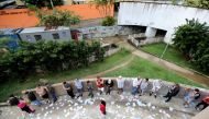 Brazilians stand in line outside a polling station to cast their votes in the presidential election, in Rio de Janeiro, Brazil October 7, 2018. REUTERS/Sergio Moraes