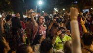 Supporters of Brazilian presidential candidate for the Workers' Party Fernando Haddad, celebrate the result after the vote count at a bar in Sao Salvador square, Laranjeiras neighborhood, in the South Zone of Rio de Janeiro, Brazil, on October 07, 2018.  