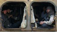 FILE PHOTO: Rebel fighters ride a military vehicle with their weapons in Dahiyet al-Assad, west Aleppo city, Syria October 30, 2016. REUTERS/Ammar Abdullah