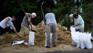 People fill bags with sand at the Lynn Haven Sports Complex while preparing for Hurricane Michael October 9, 2018 in Panama City, Florida. / AFP / Brendan Smialowski