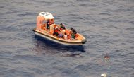 This handout photo taken on October 8, 2018 and released on October 10 by the US Navy Seventh Fleet shows Philippine fishermen, whose boat was sunk by a marlin, being rescued by US Navy personnel onto a craft from the USS Wally Schirra in the South China 