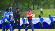 England cricket team captain Eoin Morgan (C), Umpire Aleem Dar (3L) and Sri Lankan cricketers leave the pitch as rain starts during the first one day international (ODI) cricket match between Sri Lanka and England at the Rangiri Dambulla International Cri