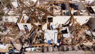A man works though the remains of an apartment in the aftermath of Hurricane Michael October 11, 2018 in Panama City, Florida.  AFP / Brendan Smialowski
 