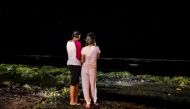 Two asylum-seekers look at the ocean in front of the community-based camp for families with children on the island of Nauru, October 2014.  © UNHCR/Vlad Sokhin