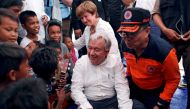 United Nations Secretary-General Antonio Guterres and World Bank CEO Kristalina Georgieva greet children while visiting a camp for displaced earthquake and liquefaction victims in Palu, Central Sulawesi, Indonesia, October 12, 2018. REUTERS/Jorge Silva