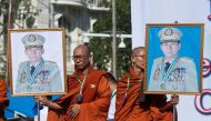 Monks hold portraits of Myanmar military commander-in-chief Senior General Min Aung Hlaing during a rally to show support to the Myanmar military in Yangon on October 14, 2018.  AFP / Ye Aung Thu 