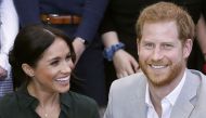 In this file photo taken on October 03, 2018 Britain's Prince Harry, Duke of Sussex (R) and Britain's Meghan, Duchess of Sussex (L) meet with young people on a visit to Joff Youth Centre in Peacehaven in East Sussex, southern England, on October 3, 2018. 