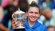 Romania’s Simona Halep celebrates with the French Open trophy at Roland Garros, Paris, France - June 9, 2018. Reuters/Charles Platiau