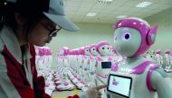 FILE PHOTO: A worker puts finishing touches to an iPal social robot, designed by AvatarMind, at an assembly plant in Suzhou, Jiangsu province, China July 4, 2018. Reuters/Aly Song