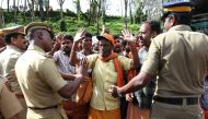 Policemen control the members of the Hindu groups at the Nilakkal Base Camp, to prevent them from clashing with women of menstrual age entering Sabarimala temple for the first time in centuries, in Pathanamthitta, in the southern state of Kerala, India, O