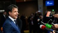Italian Prime Minister Giuseppe Conte speaks to journalists upon his arrival at the European Council in Brussels on October 17, 2018.  AFP / John Thys 