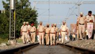 Police patrol along a railway track at the site of an accident after a commuter train traveling at high speed ran through a crowd of people on the rail tracks on Friday, in Amritsar, India, October 20, 2018. REUTERS/Adnan Abidi