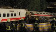 Firefighters and emergency personnel carry on rescue operations after the Puyuma Express train derailed at high speed between Dongshan and Suxin causing at least 18 dead and injuring over 150, in Taiwan's Yilan county on October 21, 2018. / AFP / Daniel M