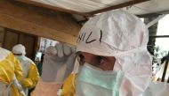 World Health Organisation (WHO) Case Management Coordinator, Dr. William Fischer, checks his PPE as he prepares to administer an Ebola therapeutic drug to patients in Mangina, the Democratic Republic of the Congo August 28, 2018. Picture taken August 28, 