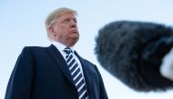 Following a campaign rally, US President Donald Trump speaks to reporters before boarding Air Force One at Elko Regional Airport in Elko, Nevada, on October 20, 2018. / AFP / NICHOLAS KAMM