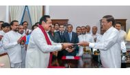 Sri Lanka's former President Mahinda Rajapaksa (Front-L) is sworn in as the new Prime Minister before President Maithripala Sirisena in Colombo, Sri Lanka October 26, 2018. (Sri Lanka's President's Office/Handout via REUTERS)