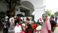 Supporters of sacked Prime Minister Ranil Wickremesinghe wait outside the Prime Minister official residence in Colombo, Sri Lanka October 28, 2018. REUTERS/Dinuka Liyanawatte
 