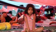 A migrant girl, part of a caravan of thousands from Central America en route to the United States, cries in a shelter as she rests in Tapanatepec, Mexico, October 27, 2018. REUTERS/Hannah McKay
 