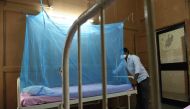 An Indian attendant places a mosquito net to a bed at an isolation ward for Zika Virus patients at Ahmedabad Municipal Corporation-run Vadilal Sarabhai (VS) Hospital in Ahmedabad on October 27, 2018.  AFP / SAM PANTHAKY
