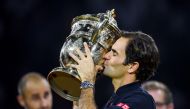 Switzerland's Roger Federer kisses the trophy after his victory against Romania's Marius Copil during their final match at the Swiss Indoors ATP 500 tennis tournament on October 28, 2018 in Basel. - / AFP / Fabrice COFFRINI