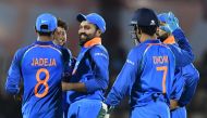 India cricketer Rohit Sharma (C) celebrates with teammates after taking the catch to dismiss West Indies batsman Ashley Nurse during the fourth one day international (ODI) cricket match between India and West Indies at the Brabourne Stadium in Mumbai on O