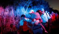 Migrants, part of a caravan traveling to the U.S., walk along the road to Huixtla, near Tapachula, Mexico, October 31, 2018. REUTERS/Carlos Garcia Rawlins 