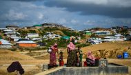 In this file photo taken on August 8, 2018 Rohingya refugees collect water at the Kutupalong refugee camp in Ukhia.  / AFP / CHANDAN KHANNA 