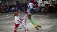 Walter Gonzales and Jenri Wasquis, two-year-old migrant boys from Honduras, part of a caravan of thousands traveling from Central America en route to the United States, play together in a makeshift camp in Sayula de Aleman, Mexico, November 2, 2018. (REUT