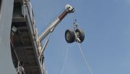 The wheels of the Lion Air flight JT 610 is lifted into the Indonesia's KRI Banda Aceh warship during a salvage operation in the Java Sea on November 2, 2018.  / AFP / ADEK BERRY 