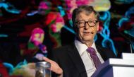Microsoft founder Bill Gates (R) talks next to a container (L) with human feces during the 