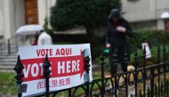 A sign announcing the location of a polling station is seen outside a church in Washington, DC on November 6, 2018. Americans started voting Tuesday in critical midterm elections that mark the first major voter test of Donald Trump's presidency, with cont