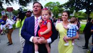Republican candidate for Governor Ron DeSantis arrives to vote, carrying his daughter Madison, in the midterm elections at a polling place, in Ponte Vedra Beach, Florida, yesterday. 