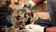 REPRESENTATIVE IMAGE: Members of the Yazidi minority search for clues, that might lead them to missing relatives in the remains of people killed by the Islamic State group a day after Kurdish forces discovered a mass grave near the Iraqi village of Sinuni