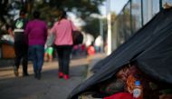 A migrant, part of a caravan of thousands travelling from Central America en route to the United States, rests in a makeshift camp in Mexico City, Mexico, November 8, 2018. REUTERS/Hannah McKay 