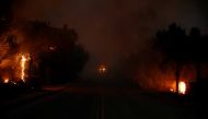 The Woolsey Fire burns in Malibu, California, U.S. November 9, 2018. The fire destroyed dozens of structures, forced thousands of evacuations and closed a major freeway. REUTERS/Eric Thayer