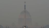 A pedestrian crosses a road near the Indian President's house amid heavy smog in New Delhi on November 8, 2018. AFP / Money Sharma 