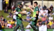 South Africa's batsmen David Miller (L) and Faf du Plessis (R) celebrate scoring their centuries against Australia during the third one-day international cricket match in Hobart on November 11, 2018. AFP / WILLIAM WEST 