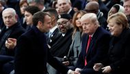 French President Emmanuel Macron walks past German Chancellor Angela Merkel, U.S. President Donald Trump, first lady Melania Trump, Morocco's King Mohammed VI, his son Crown Prince Moulay (hidden) Canadian Prime Minister Justin Trudeau and Israeli Prime M