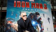 Stan Lee gestures as he poses at the premiere of 