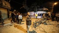 Residents inspect the damage after the Israeli airstrikes hit the Hamas-run Al-Aqsa TV in Gaza on November 12, 2018. (Mustafa Hassona/Anadolu Agency)