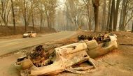 Burned cars litter a road during the Camp fire in Paradise, California on November 12, 2018.  AFP / Josh Edelson
