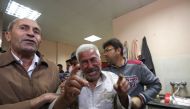 The relative of a man killed in an Israeli air stike across the Gaza Strip reacts after identifying his body at a hospital morgue in Beit Lahya on November 13, 2018. AFP /Mahmud Hams
 