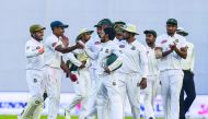 Bangladesh cricketers congratulate teammate Taijul Islam (2R) as they walk off the field after the third day of the second Test cricket match between Bangladesh and Zimbabwe at the Sher-e-Bangla National Cricket Stadium in Dhaka on November 13, 2018. AFP 