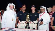 Manateq CEO Fahad Al Kaabi (left) and Qatar Motor and Motorcycle Federation (QMMF) President Abdulrahman Al Mannai (right) pose for a photograph with Qatari driver Nasser Saleh Al Attiyah and his navigator Matthieu Baumel after presenting the 14-time regi