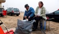 Anna and William Goodnight, of Paradise, sit outside their tent at a makeshift evacuation center for people displaced by the Camp Fire in Chico, California, November 15, 2018. Reuters/Terray Sylvester  
