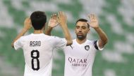 Al Sadd’s saviour, Ali Asadallah celebrates with skipper Xavi Hernandez after scoring their third goal against Al Sailiya during their QSL Cup match played at the Hamad Bin Khalifa Stadium yesterday.
