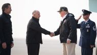US President Donald Trump greets California Governor Jerry Brown and Governor-elect Gavin Newsom (L) as he arrivesl at Beale Air Force Base in California, November 17, 2018. Trump is in California to view fire damage. / AFP / SAUL LOEB